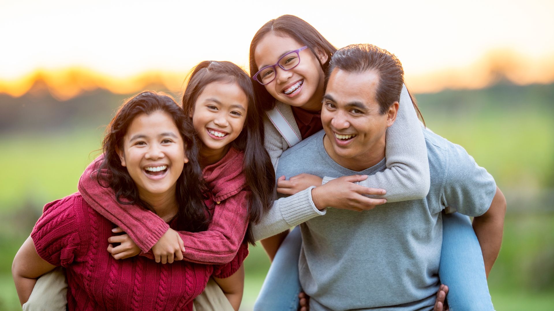 Smiling family posing for a photo, showing love and happiness.